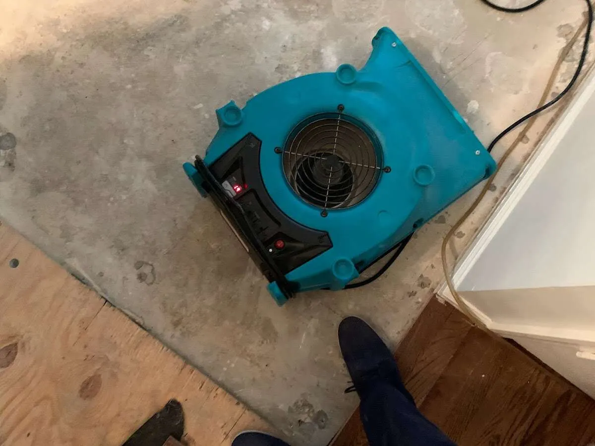 Air mover drying subfloor during Commercial Water Damage Restoration in Grove City